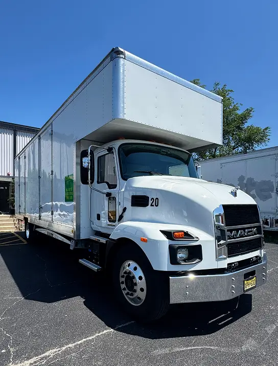 Stanford Van Lines box truck parked at a job site