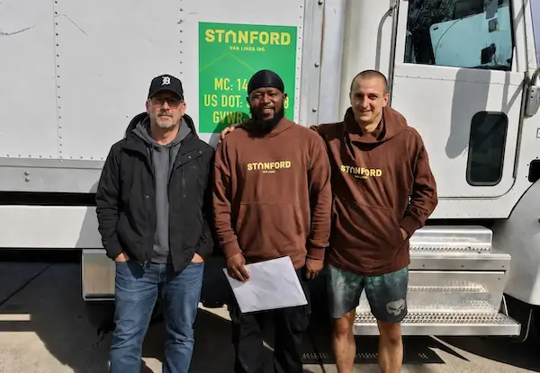 Stanford Van Lines moving crew in front of a company truck