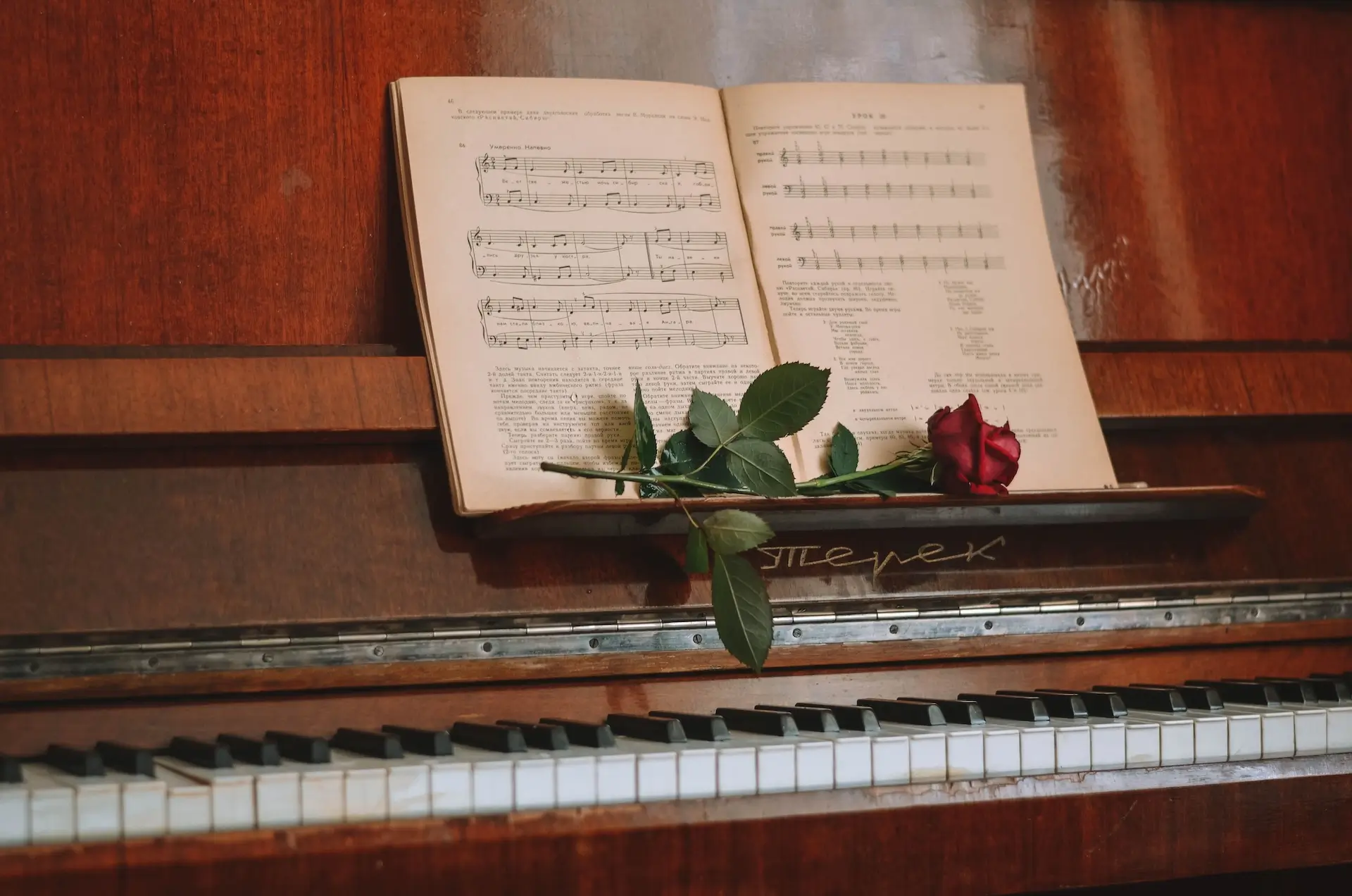 Piano movers manoeuvring an upright piano during a move